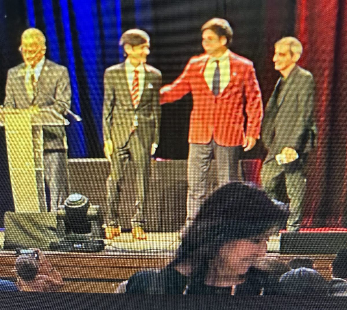 Three Town commissioners on stage at a political party's county event, September 13, 2025